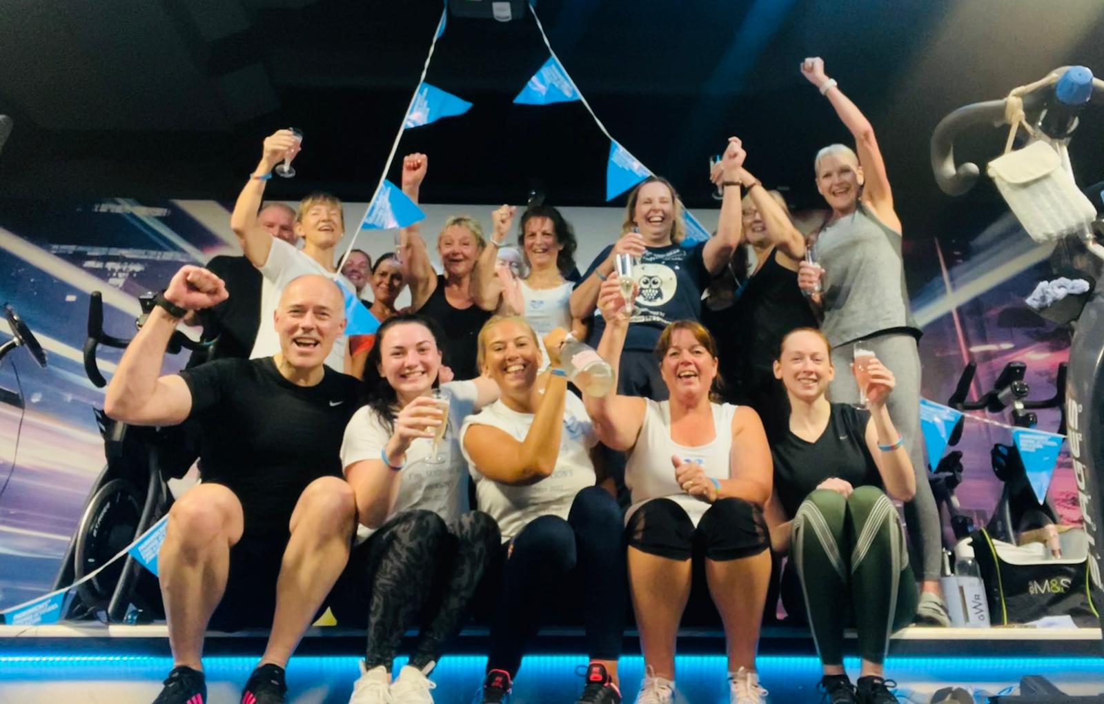 A group celebrating together beneath Parkinson’s UK bunting